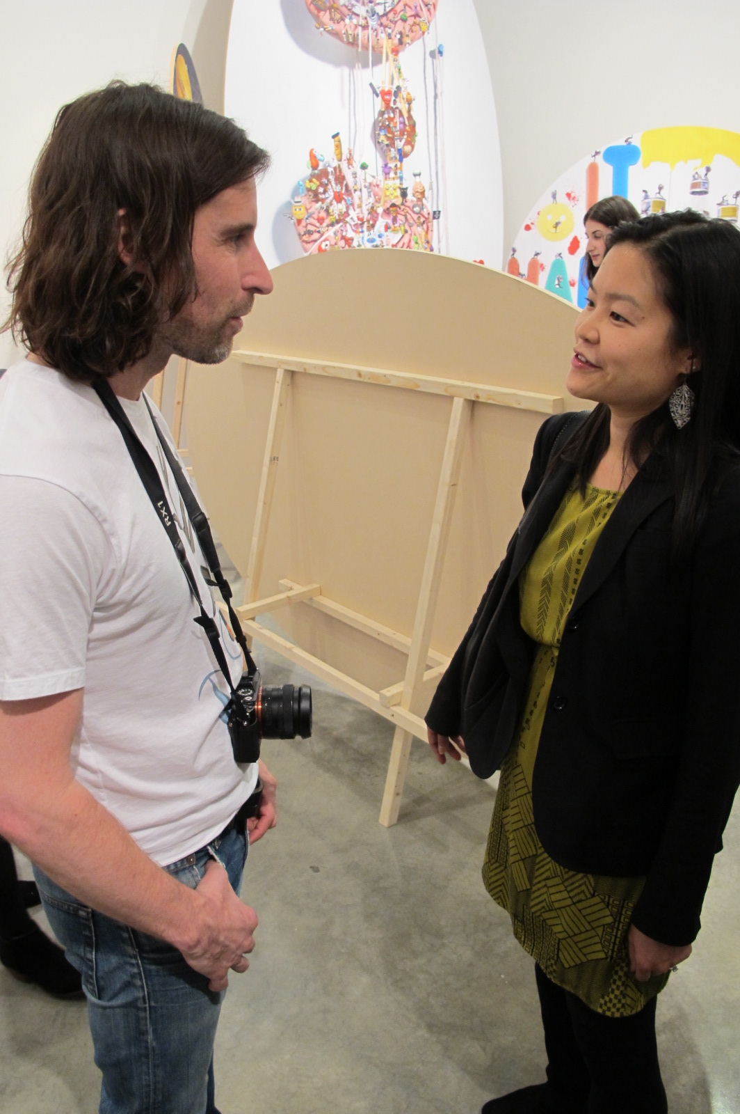 Artist Olaf Breuning talking to a guest