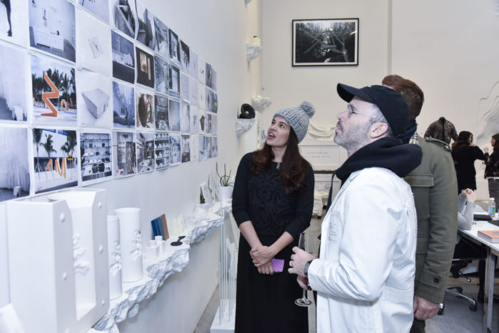 Daniel Arsham showing his architectural renderings to the guests